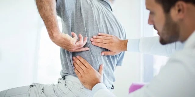 man having a back examination